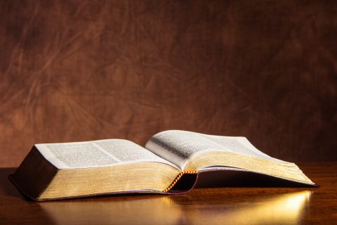 Open Bible on a wood desk